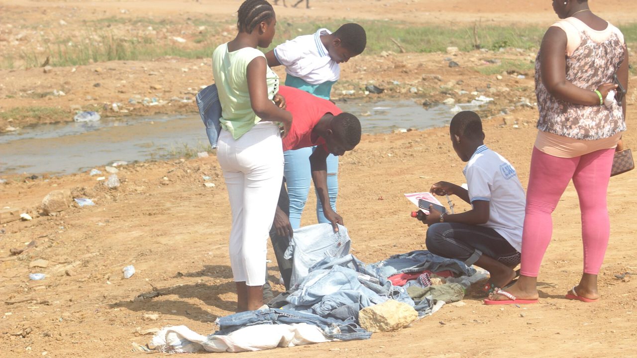A young man selling second-hand clothing in Ghana
