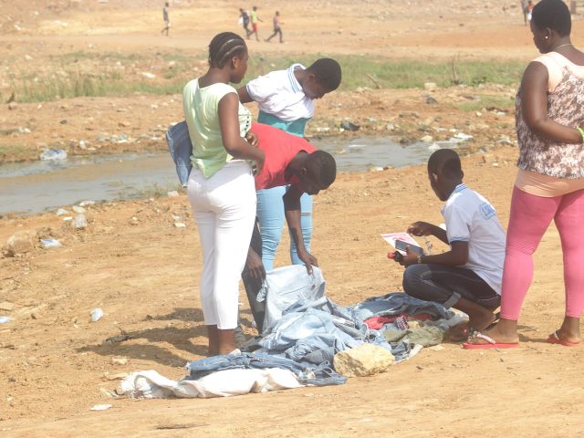 A young man selling second-hand clothing in Ghana