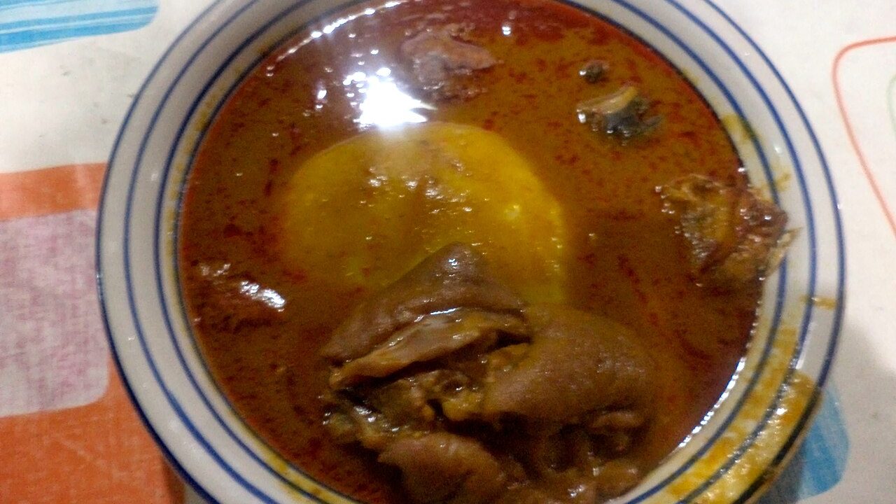 Fufu with palm nut soup, snail and tilapia