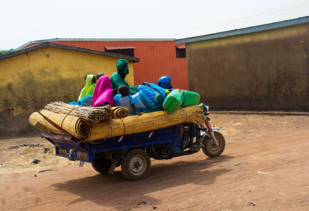 A tricycle carrying passengers and loads
