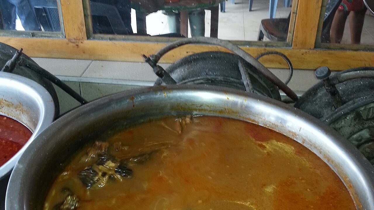 Palm nut soup served in a chop bar