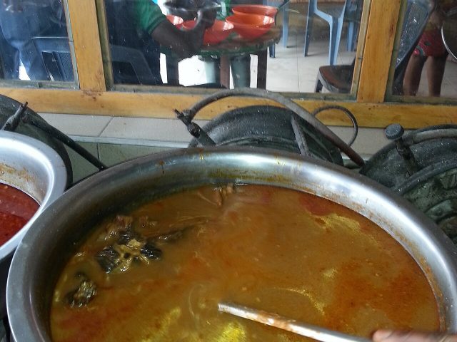 Palm nut soup served in a chop bar