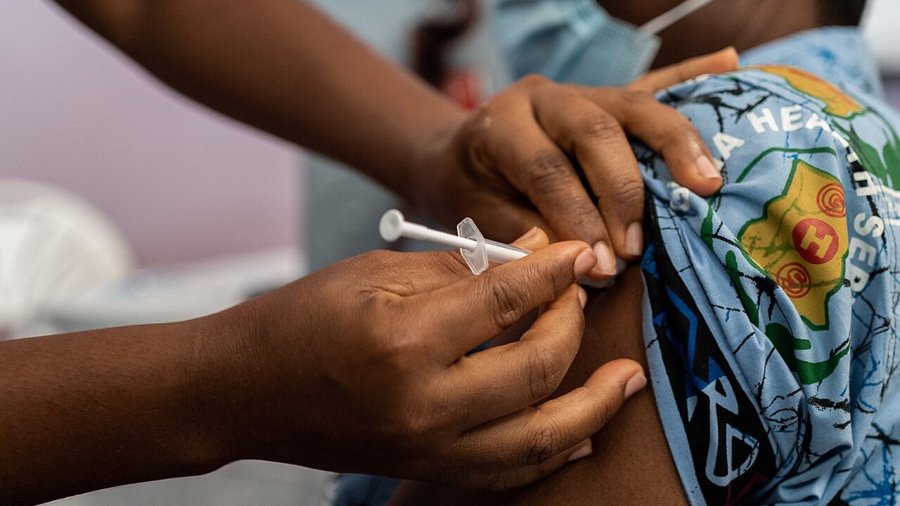 A doctor in Ghana receives a COVAX vaccine dose in March 2021