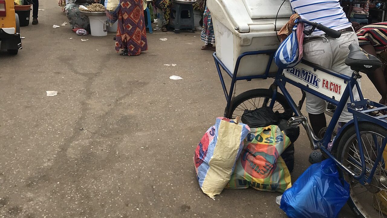 A Fan Milk vendor selling frozen products from a bicycle