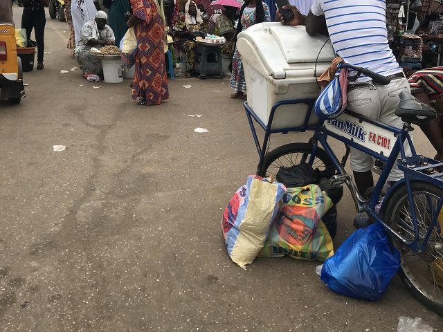 A Fan Milk vendor selling frozen products from a bicycle
