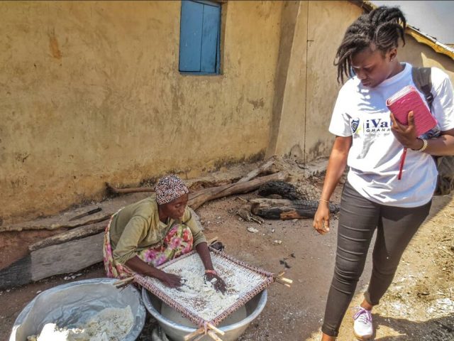 A woman processing cassava for gari in Ghana