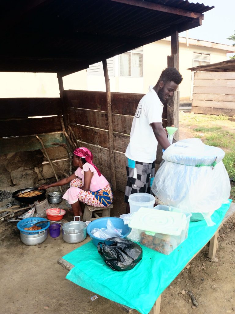 A Hausa koko seller serving a customer