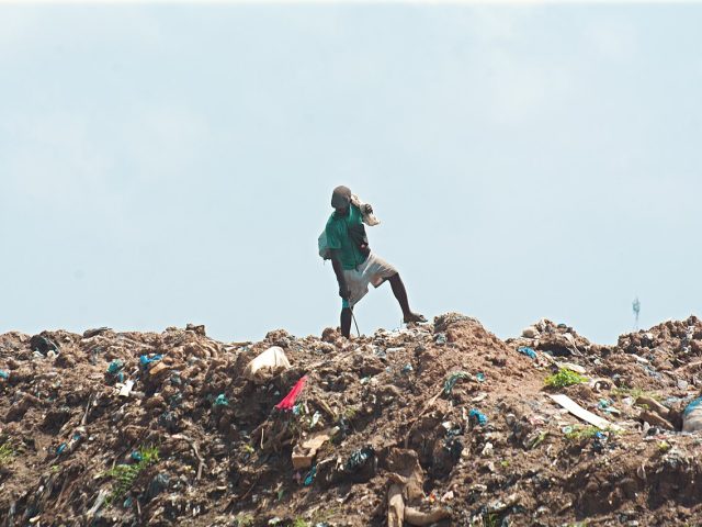 A waste picker at a landfill site in Ghana