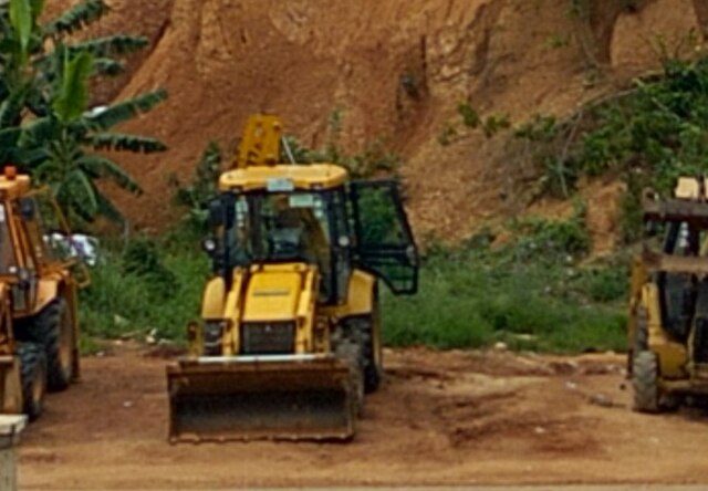 Earth-moving equipment at a galamsey site