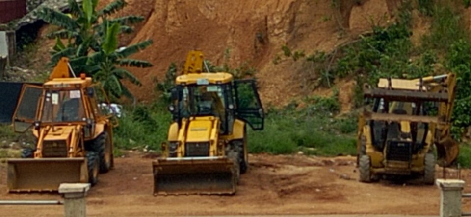 Earth-moving equipment at a galamsey site
